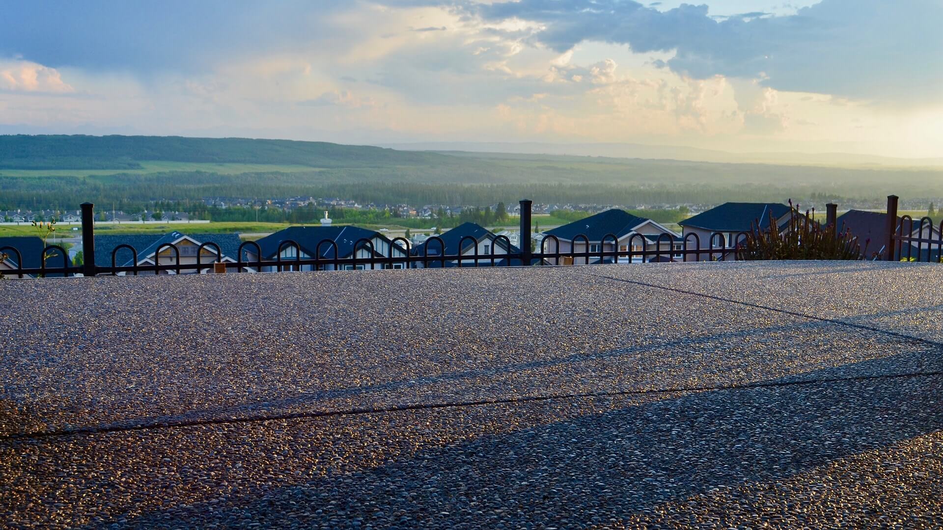 Exposed Aggregate patio is shown from a low angle against a backdrop of the hills of Elbow Valley in Calgary.