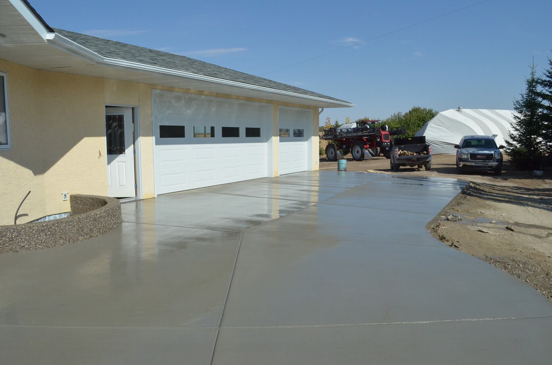 A newly finished Cut&Broom concrete driveway is being water cured to ensure quality strength gains are achieved.